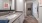 Large well lit bathroom with large mirror and white cabinets in unit bathrooms at Lake House