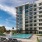 Spacious sparkling pool with sundecks and cabanas for lounging surrounded by Lake House's building
